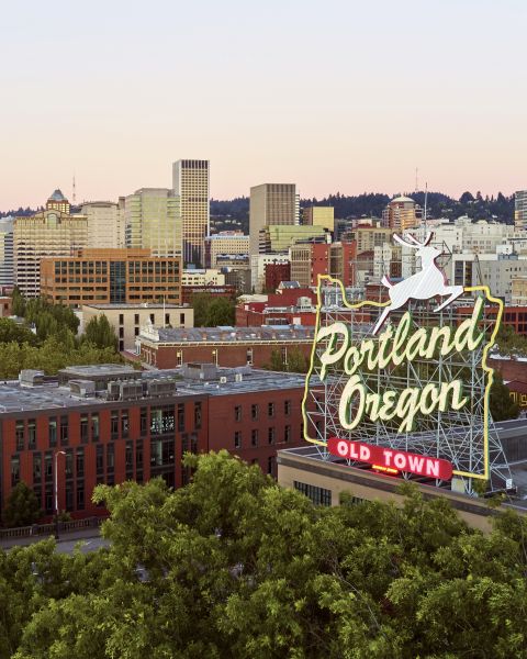 an aerial view of a city behind a sign that reads Portland, Oregon