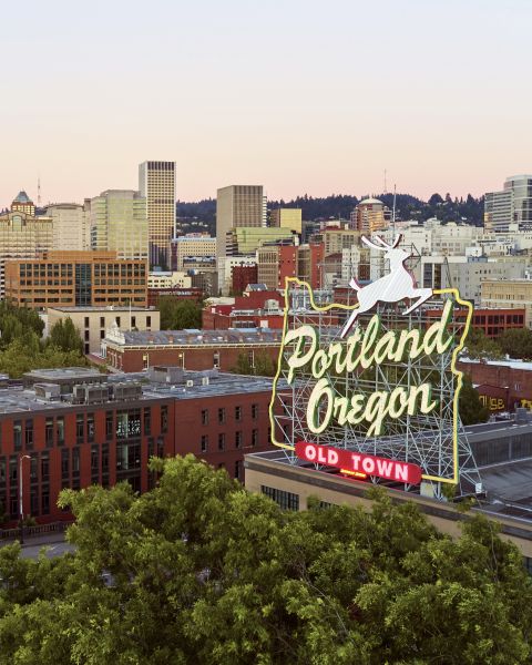 an aerial view of a city behind a sign that reads Portland, Oregon