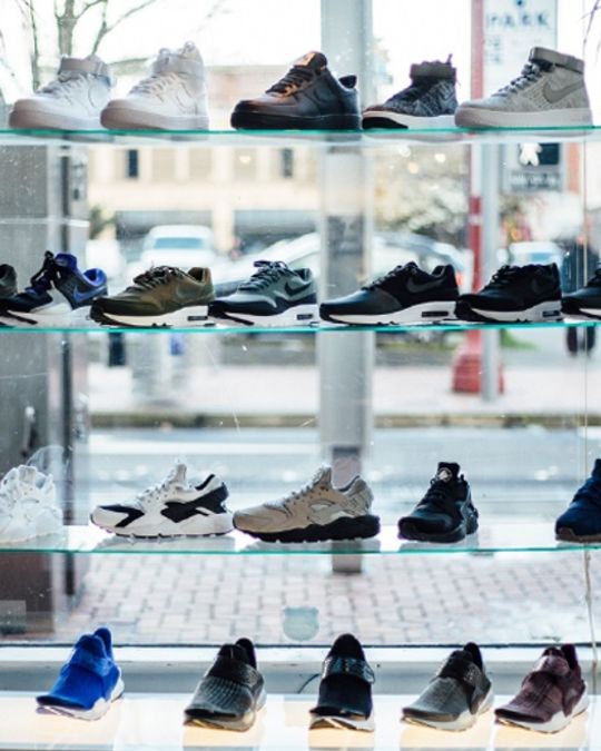 four rows of shoes displayed in a retail shop window