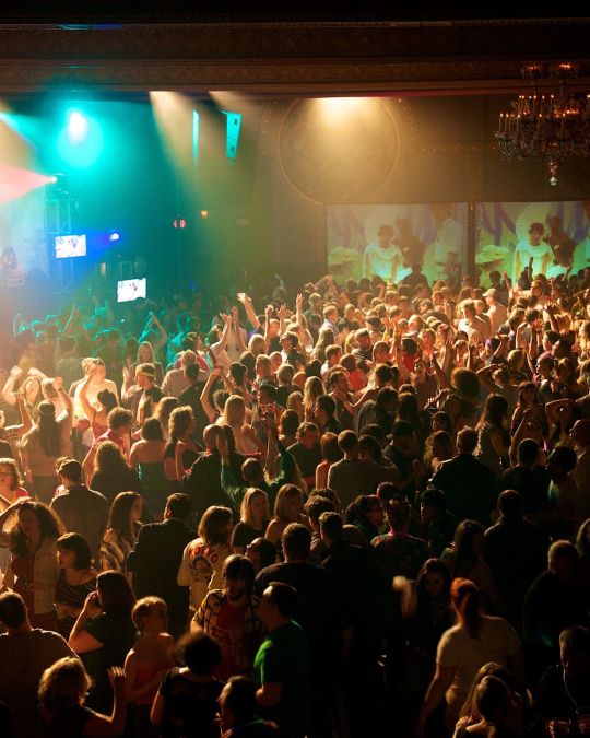 a crowd of people dancing in a night club
