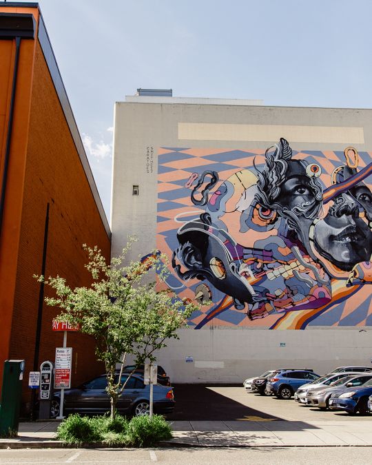mural on side of building on a city street