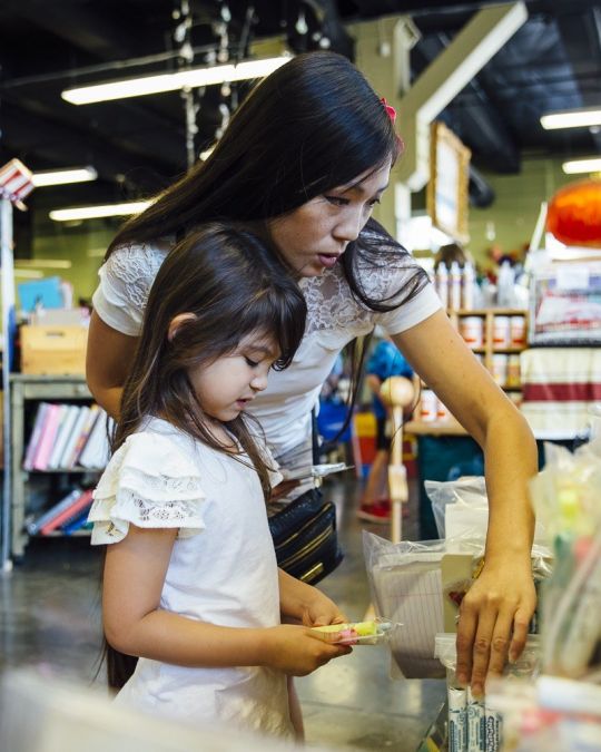 A family browses school supplies at Scrap.