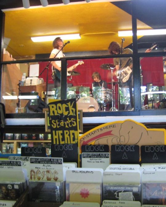 a band playing live at Music Millennium