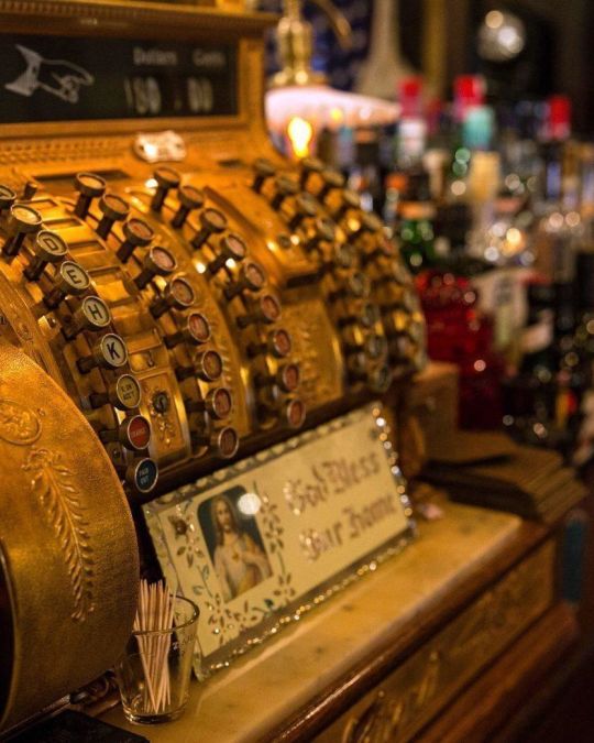 an old-time cash register on a bar