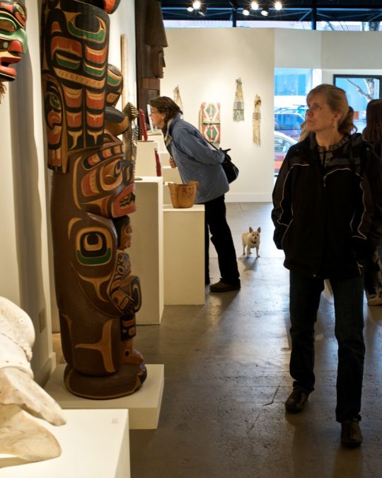 people admiring Native American art on display in a gallery