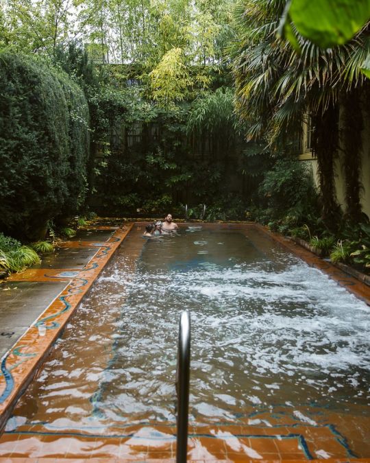 a man enjoying a warm water, outdoor pool