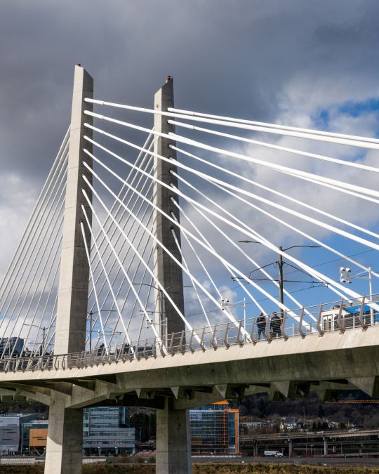 tilikum crossing bridge with blue skies and clouds in background