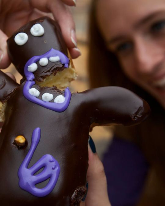a humanoid-shaped donut being split in two