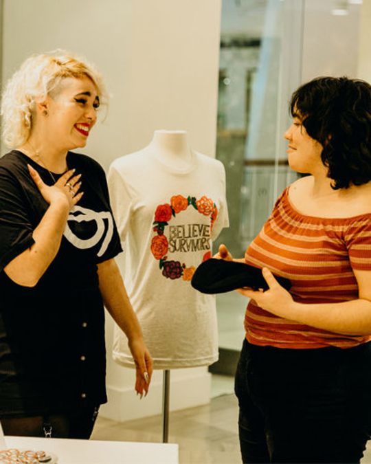 Dfrntpigeon\'s youth business manager Anna Coghill speaks with a shopper.