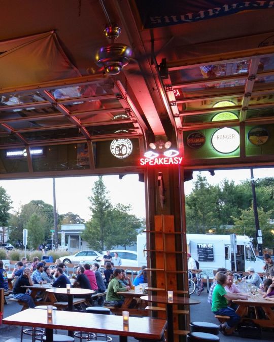 outdoor tables at Apex Bar filled with people