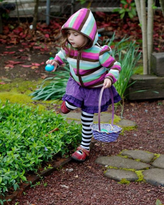 a child collecting easter treats in a basket