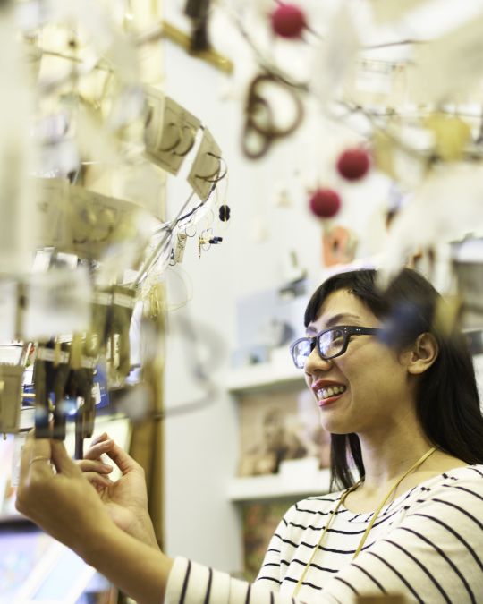 A person looking through the jewelry display at Tender Loving Empire.