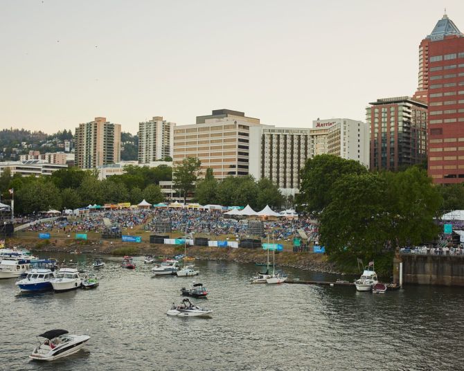 overhead view of downtown portland's waterfront full of tents and willamette river full of boats