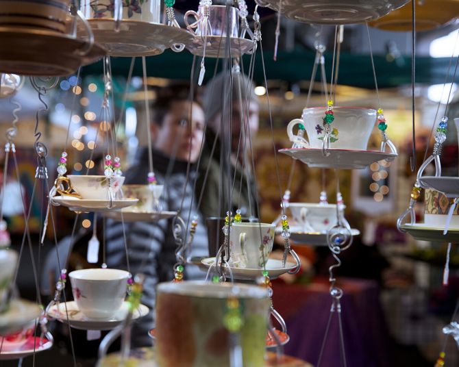 hanging teacups and saucers on display for sale