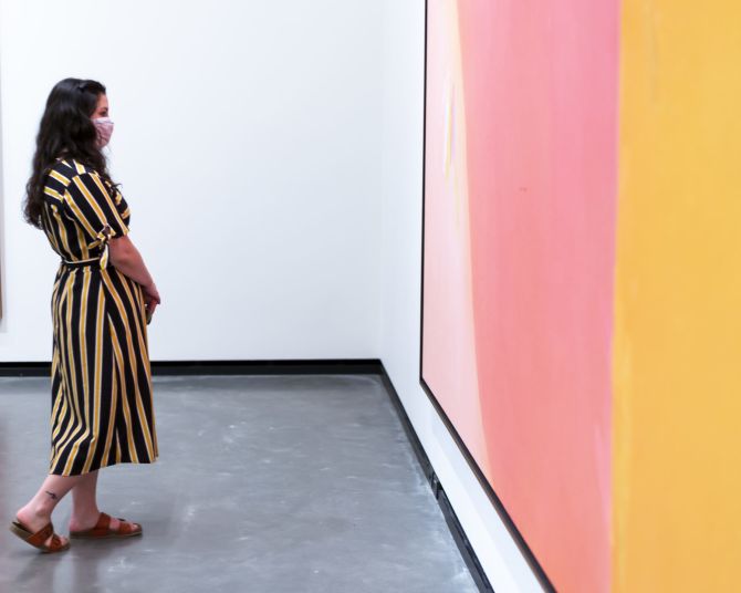 a visitor looks at a large modern art painting in the Portland Art Museum