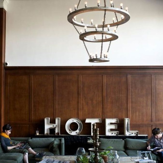People sitting on a couch in a hotel lobby