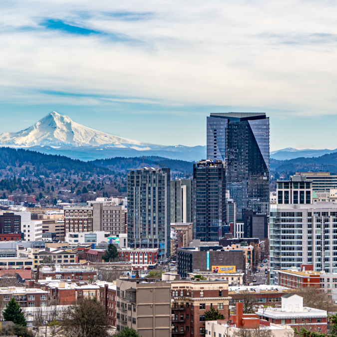 an overhead view of the Portland skyline with the snowy peak of Mount Hood in the background