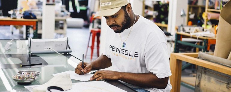 a designer looks at a sneaker