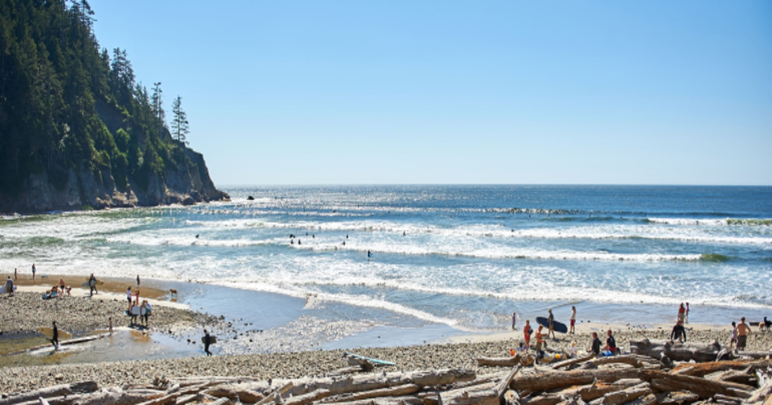 rugged coastline and a sandy beach on a sunny day