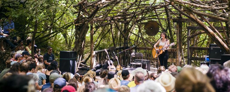 a musician performs on an outdoor stage