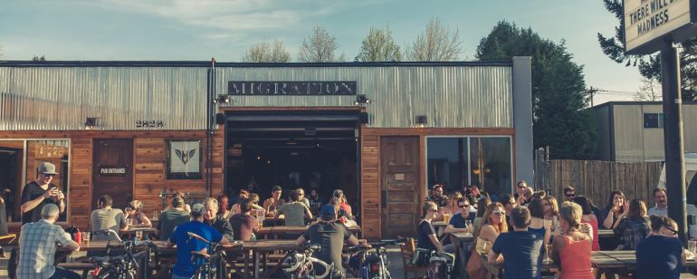 people sitting and drinking at brewery patio
