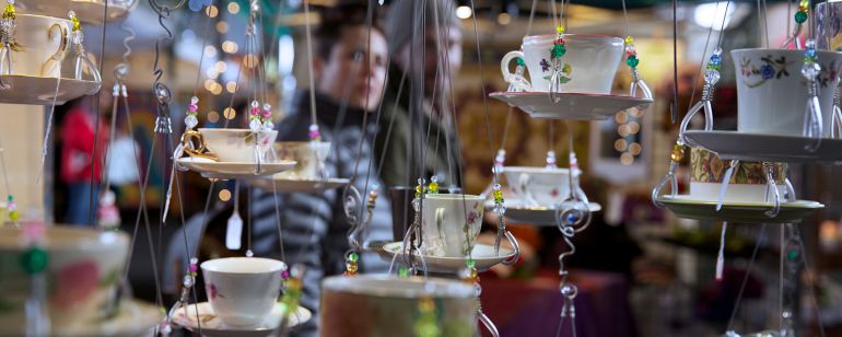hanging teacups and saucers on display for sale