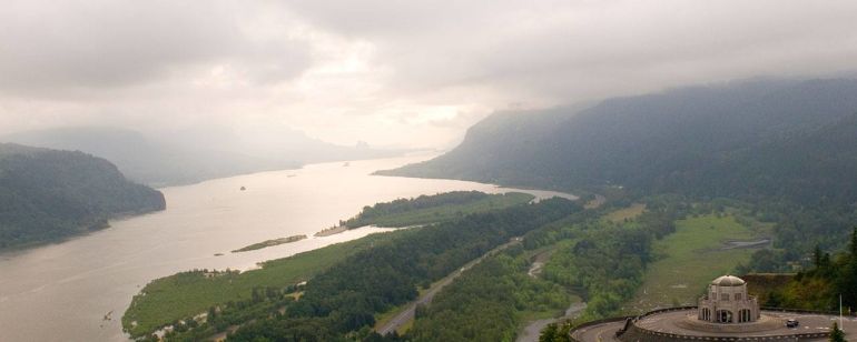 A magnificent view up the Columbia River Gorge, the golden light of a setting sun hitting the cliffs below the Vista house.