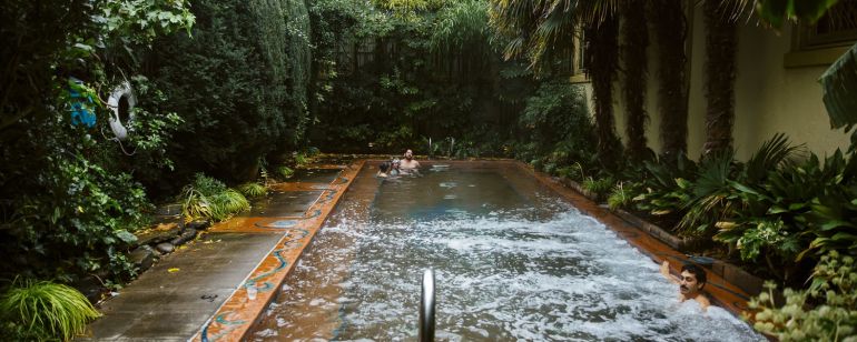 a man enjoying a warm water, outdoor pool
