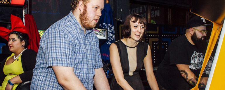 two people playing arcade games at Ground Kontrol