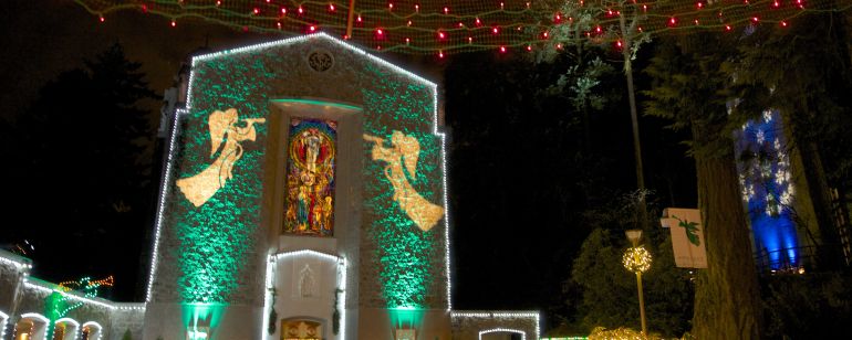 Building entrance decorated with festive lights at night time