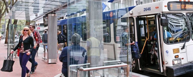 People entering and exiting a TriMet bus downtown