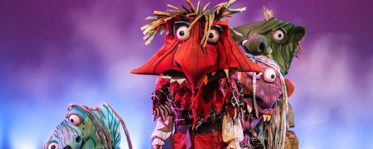 Four large headed scary/funny monsters on stage