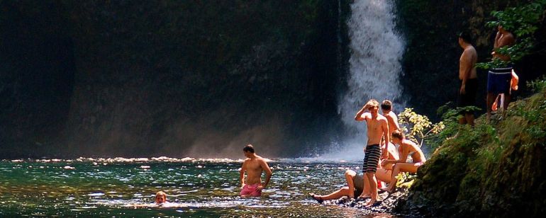 Happy swimmers spend a hot summer afternoon in the cool, clear waters of Punchbowl Falls.
