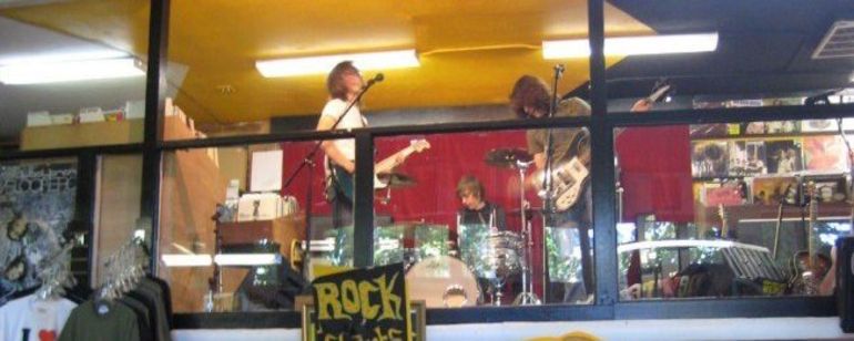 a band playing live at Music Millennium