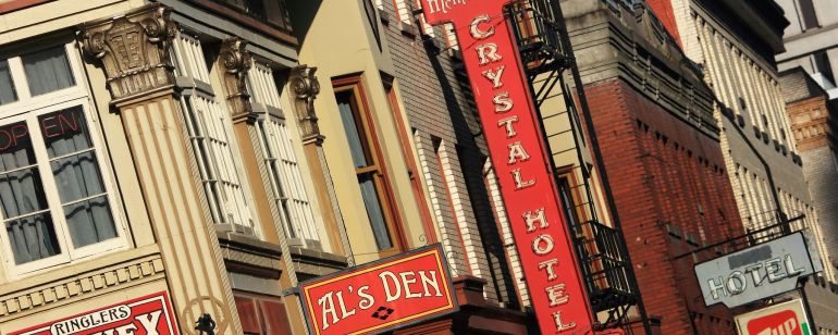 A historic building with a variety of business signs
