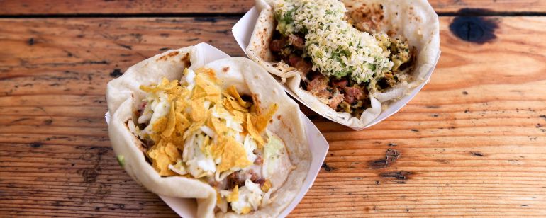 two tacos on a wooden table