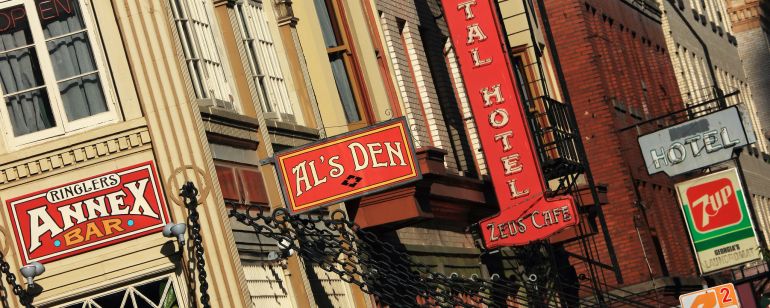 A historic building with a variety of business signs