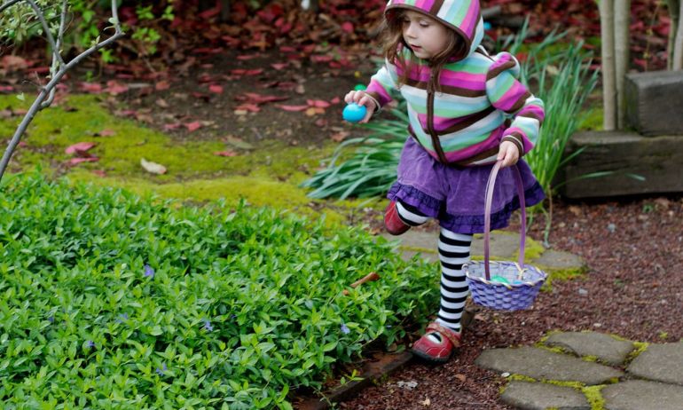 a child collecting easter treats in a basket