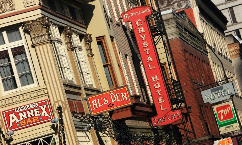 A historic building with a variety of business signs