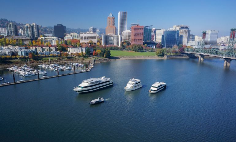 four cruise ships of varying sizes on the Willamette River