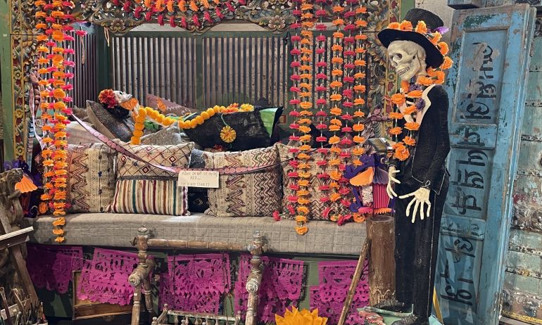 A large pink altar with skeletons and marigold created by artist Jessica Lagunas for Dia de Los Muertos