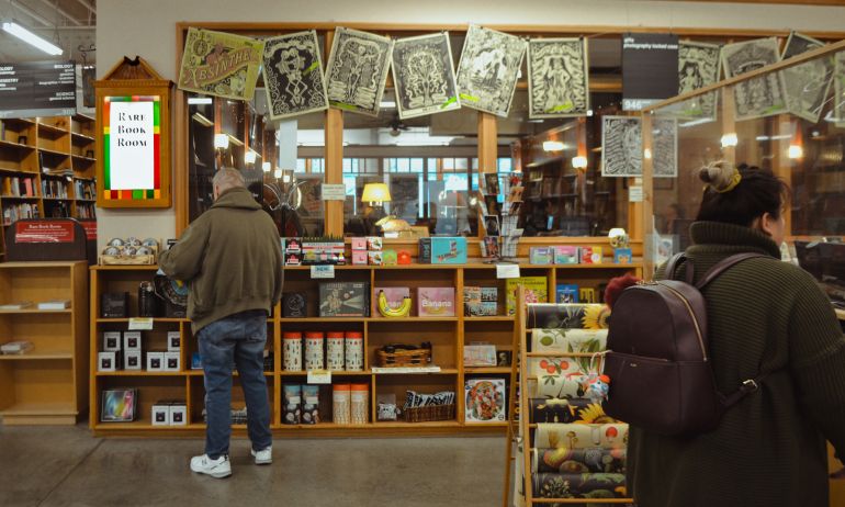people at books shelves in a books store