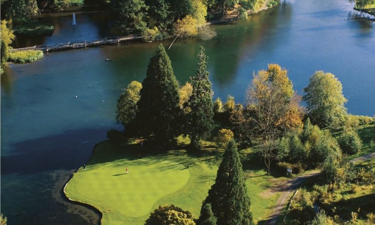 arial shot of golf course with lake