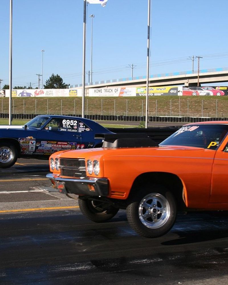 Two cars drag race at Portland International Raceway.