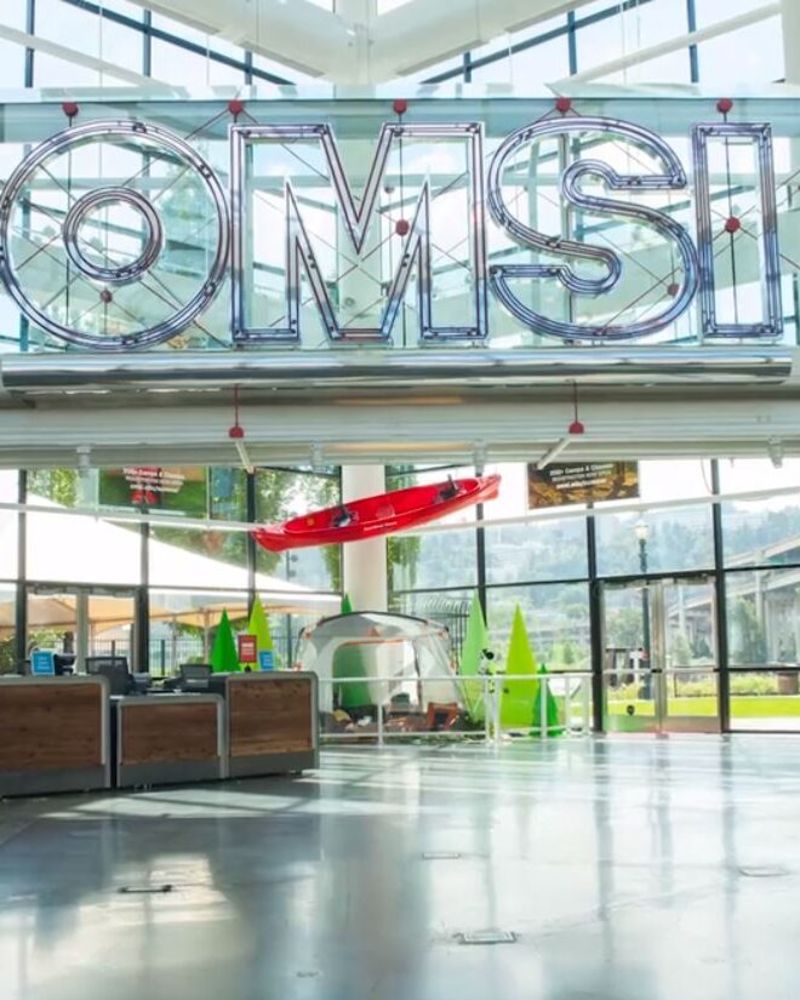 glass atrium lobby with large lettering reading OMSI