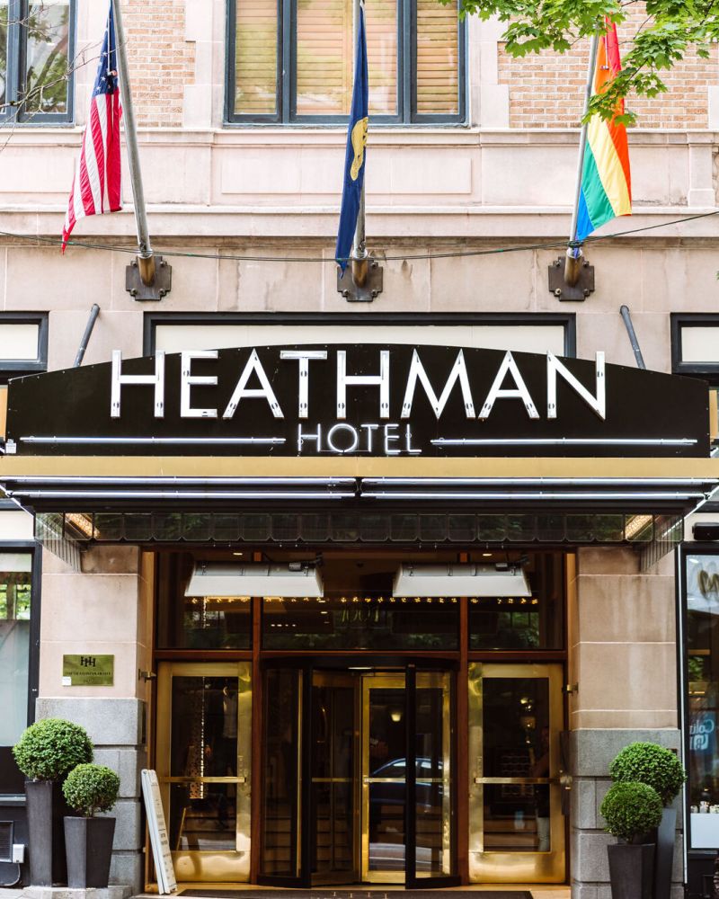 Entrance to the Heathman Hotel with flags hanging above.