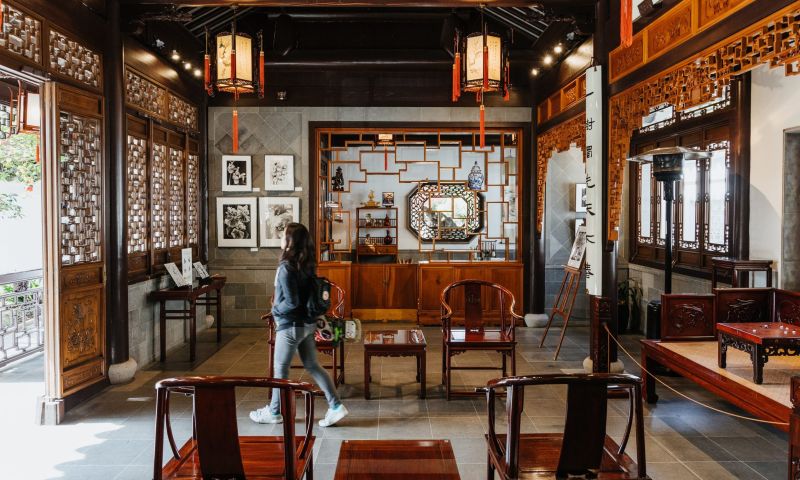 woman walking through ornate room