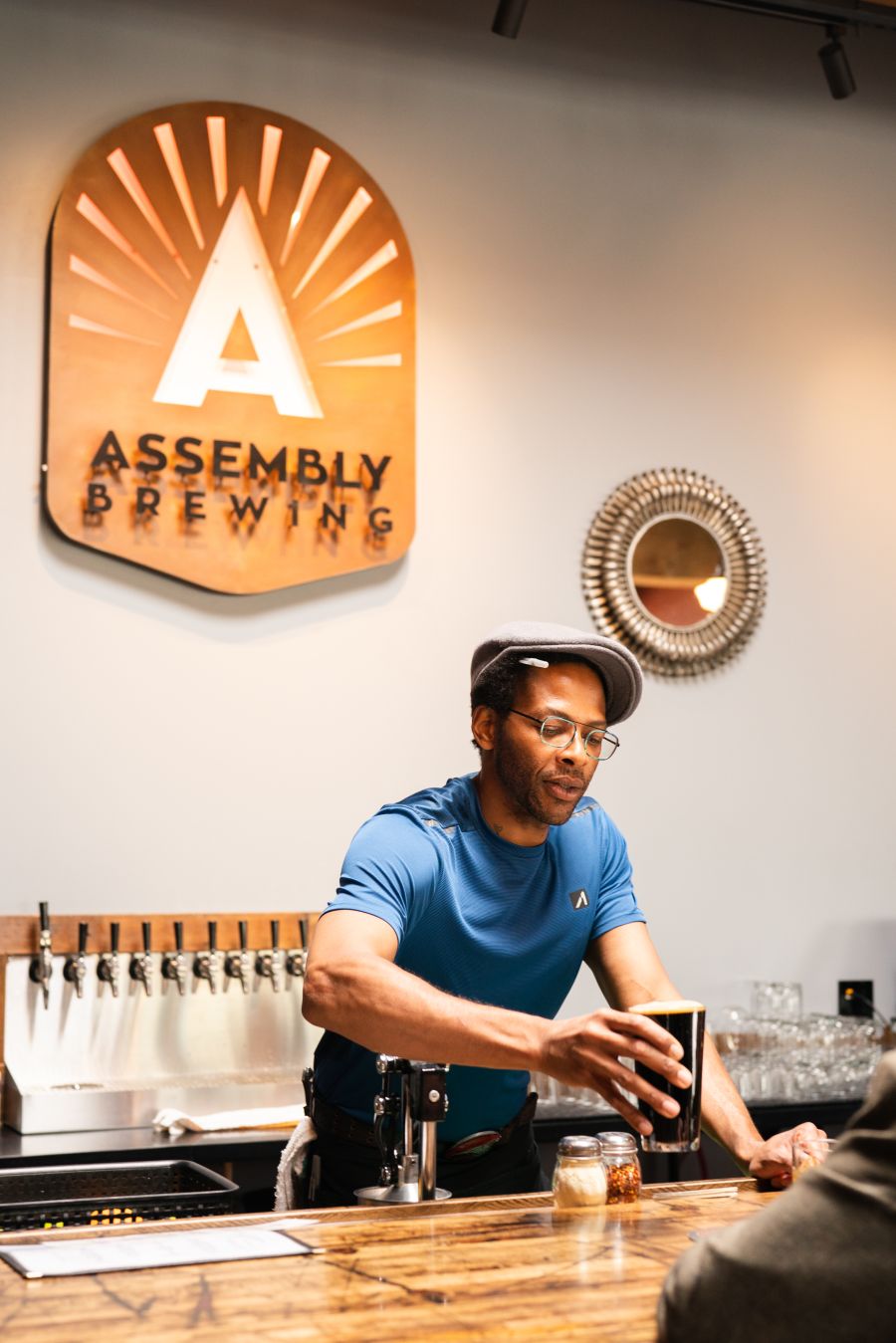 A man serves a glass of beer