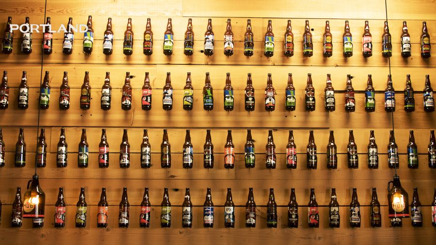 beer bottles displayed in lines against a wall