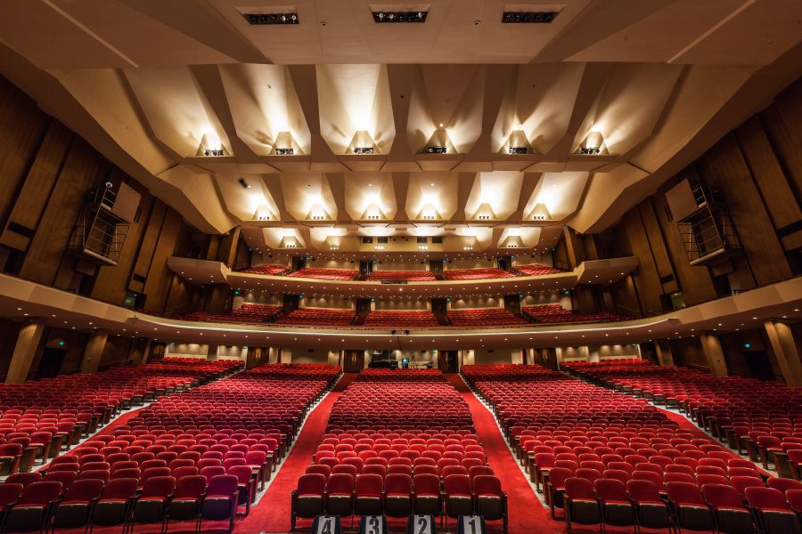 the interior of the Keller Auditorium, a large space with multiple tiers of red velvet seats